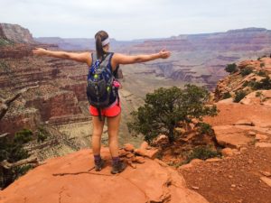 Hiker at the top of a red rock mountain-sedona experience