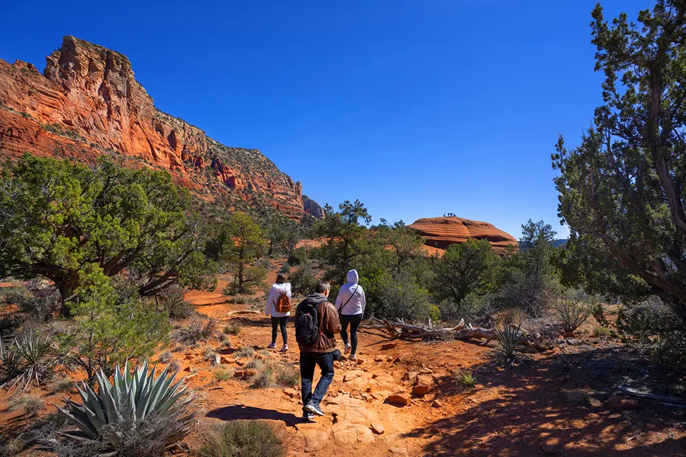 group hikes out on the red rocks for a sacral chakra vortex tour